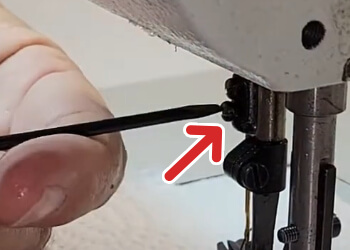 2. Loosen the lower of the two screws