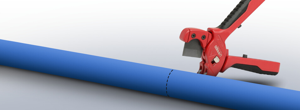 Put the part of the PEX pipe you need to cut into the tubing cutter